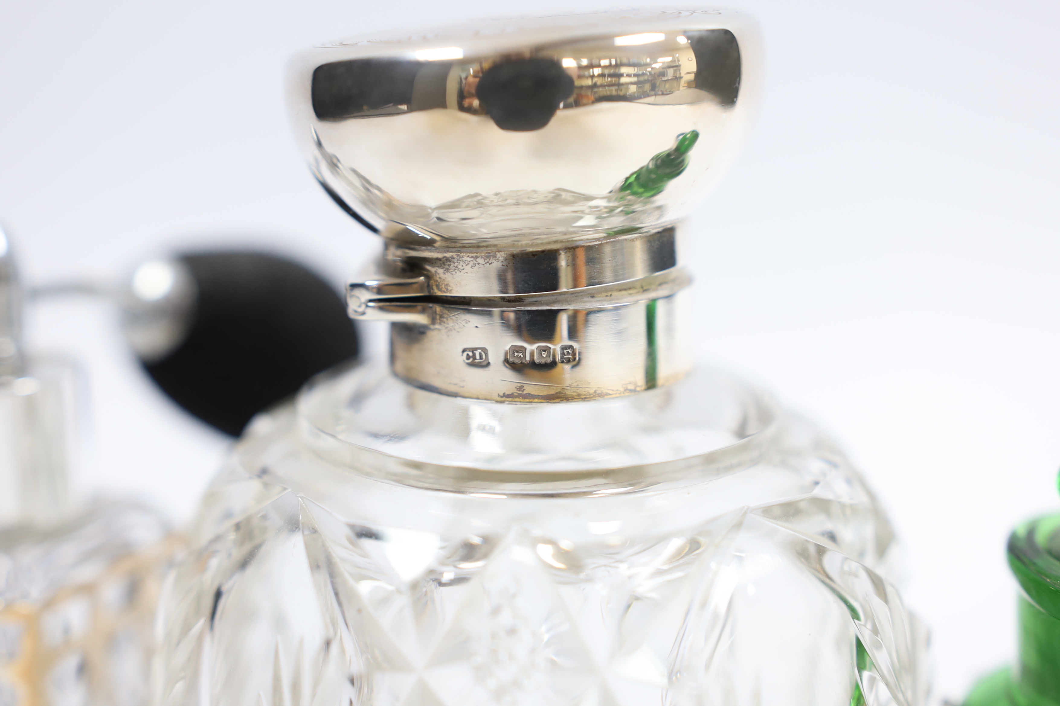A George V silver mounted cut glass globular scent bottle, London, 1918, lacking stopper?, 11.2cm and three other silver mounted toilet jars.
